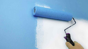 paint roller painting wall blue