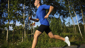 man jogging through park