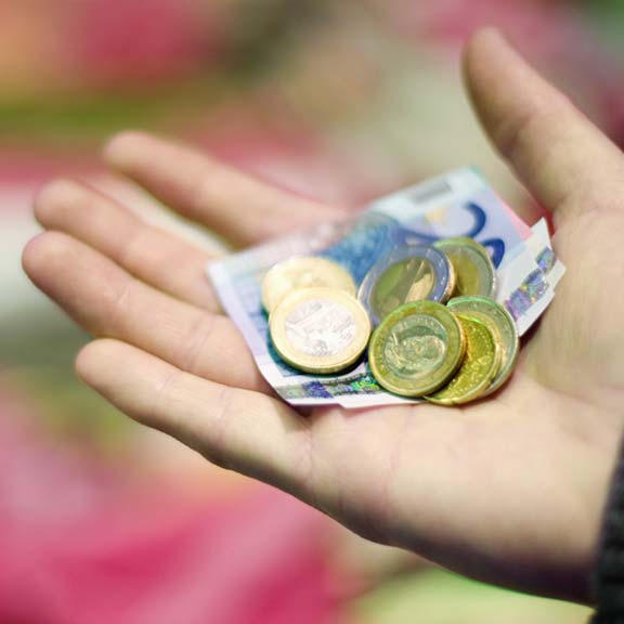 hand holding foreign currency square