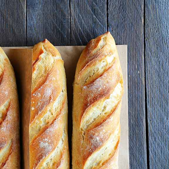 rolls of bread on dark background sq