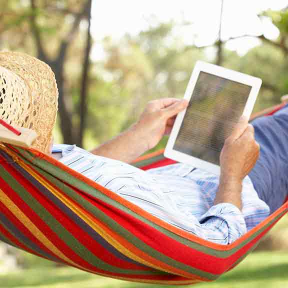 person using tablet on hammock square