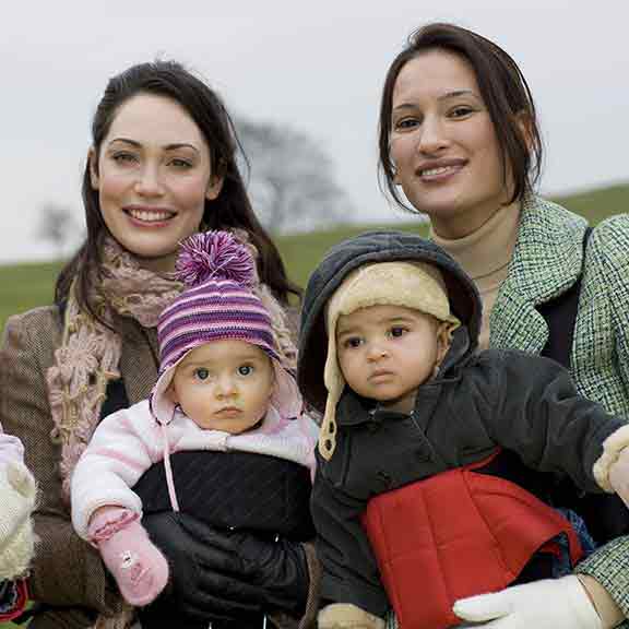 three mums with their babys in carriers square