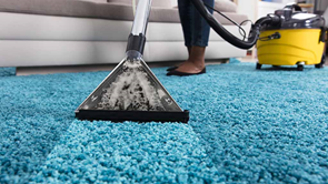 person using an at home carpet cleaner