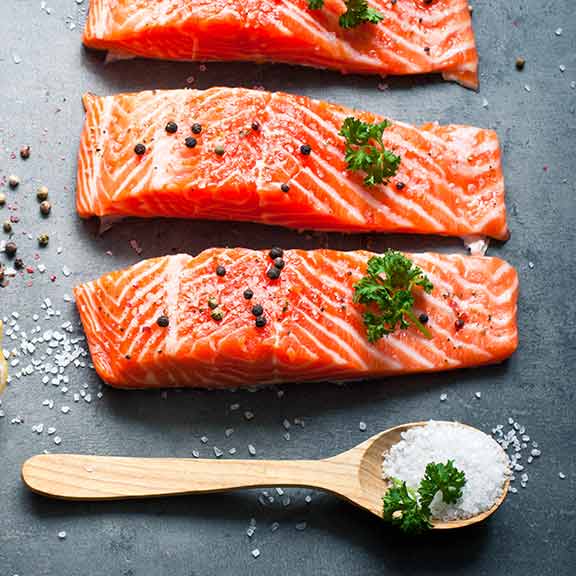 salmon steaks on kitchen board sq