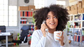 young woman using landline phone