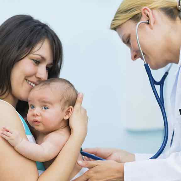 mother holds baby while nurse listens to hear beat square