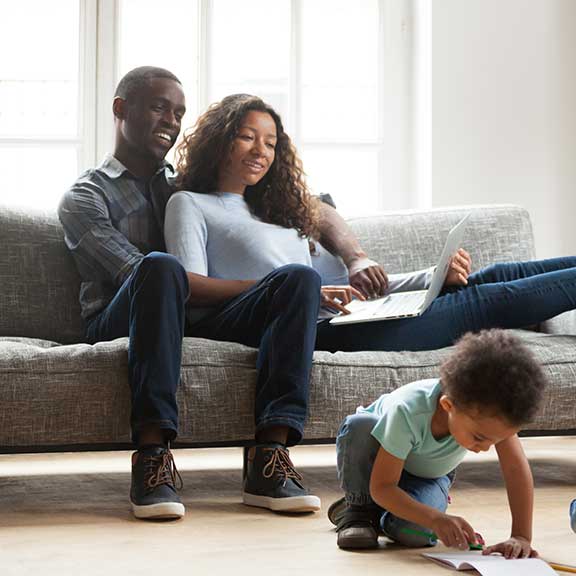 family sitting on sofa lounge sq