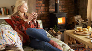 woman heating home with a fire