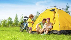 family sitting in a tent