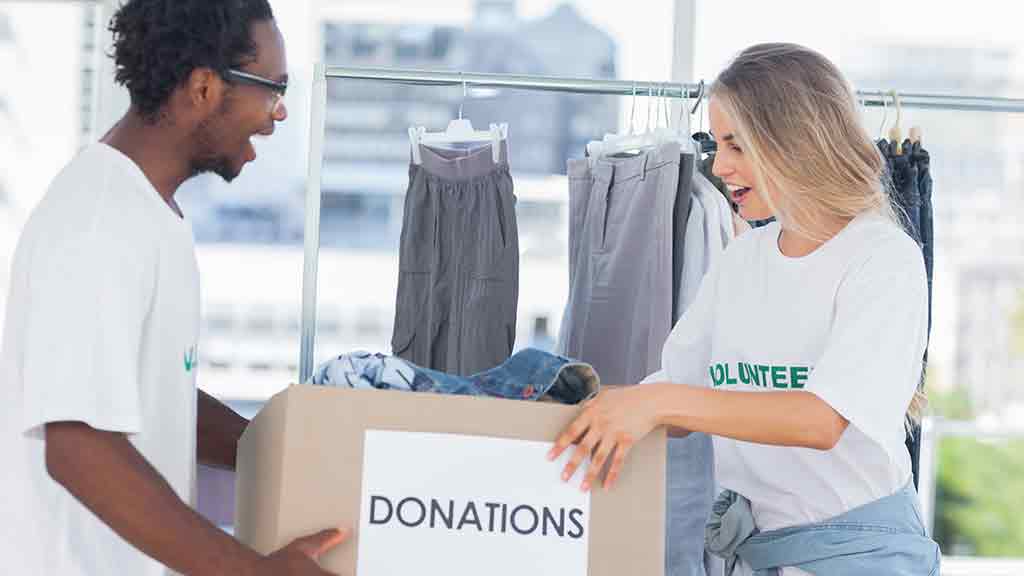 two people hold donations box