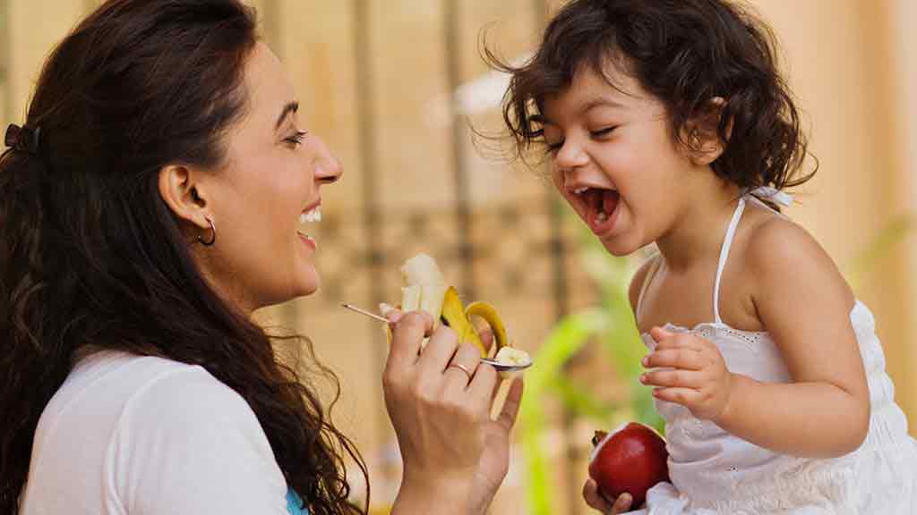 mother feeding her daughter